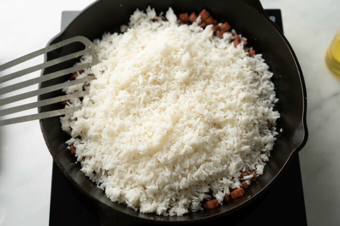 adding rice to pan