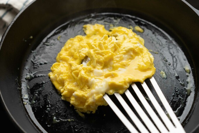 cooked scrambled egg in cast iron pan