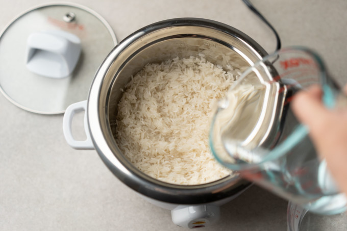 pouring water into Aroma select stainless rice cooker