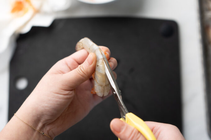cutting into back of shrimp with shears