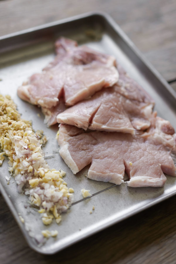 prepared aromatics: shallots and garlic, with cut pork chops