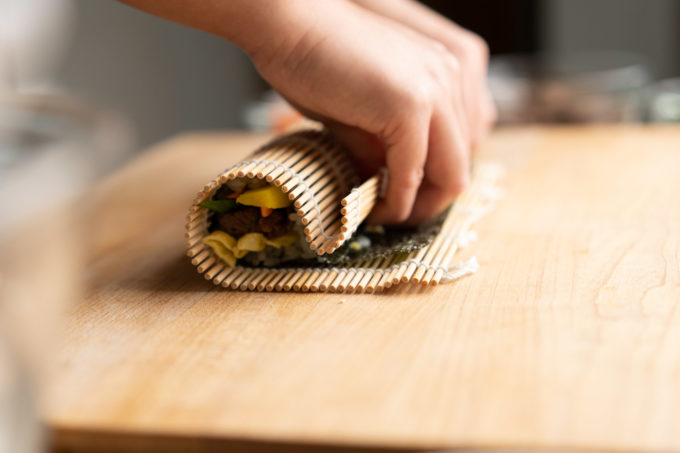 rolling kimbap with sushi mat