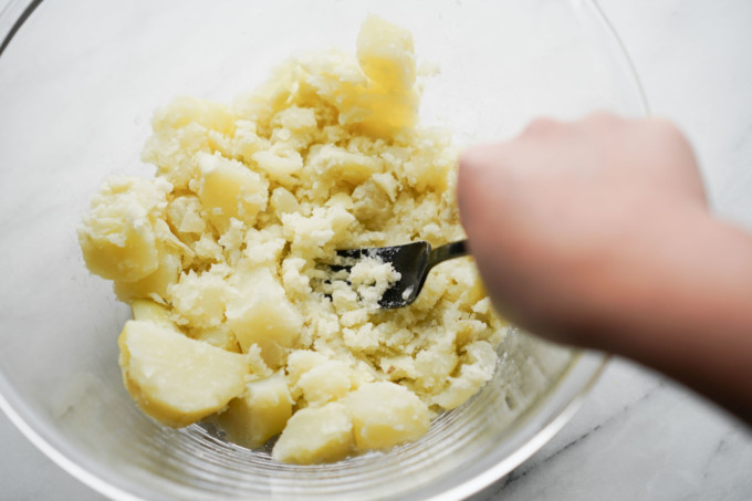 mashing potatoes with a fork