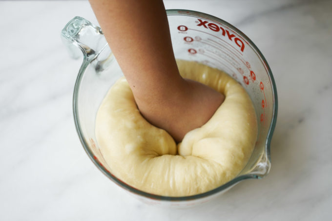 punching down dough to remove air