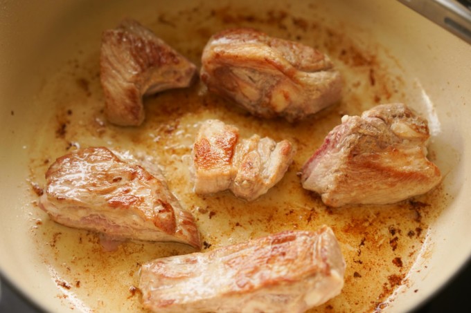 searing pork in a pot